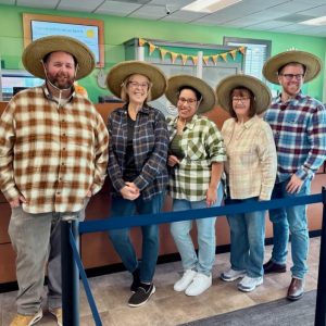 Employees dressed up as farmers for Halloween.