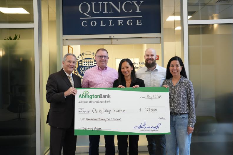 A check donation for Quincy College Foundation.