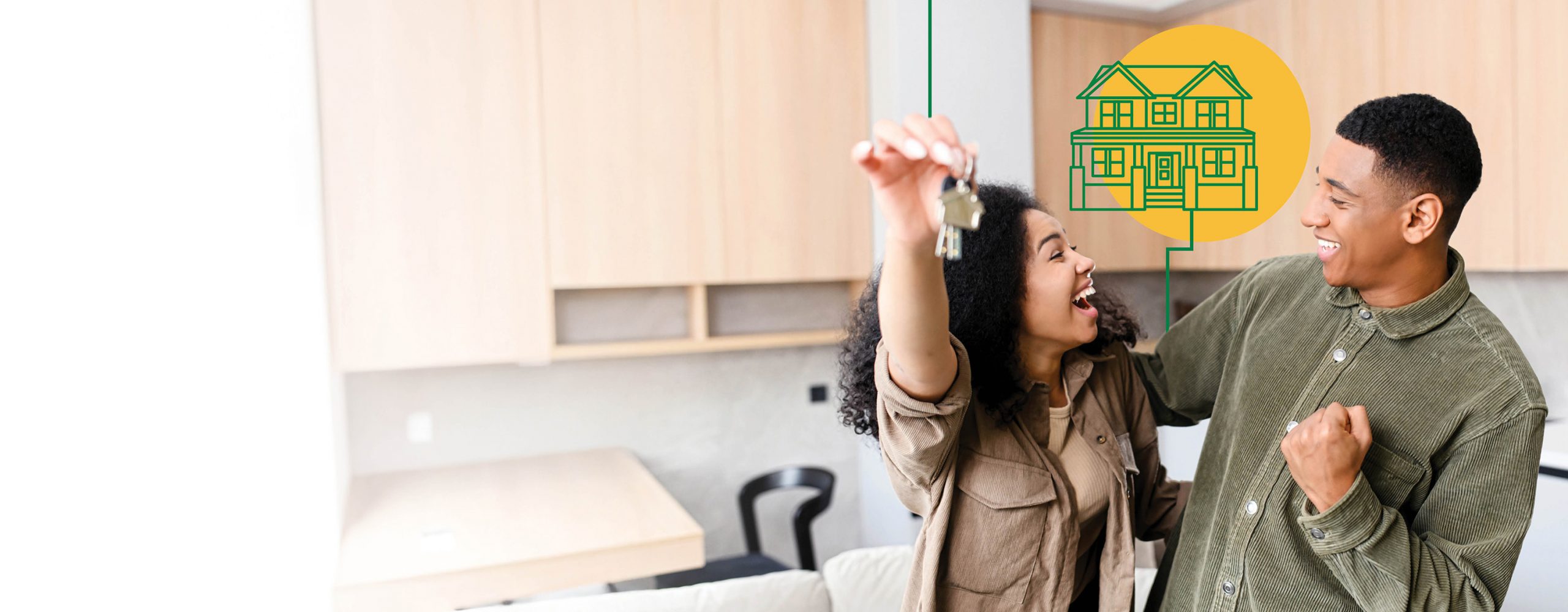 A couple holding keys standing in the kitchen of their new home.