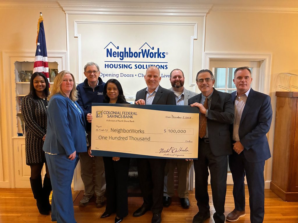 A check donation to NeighborWorks from our charitable giving program, The Giving Tree.