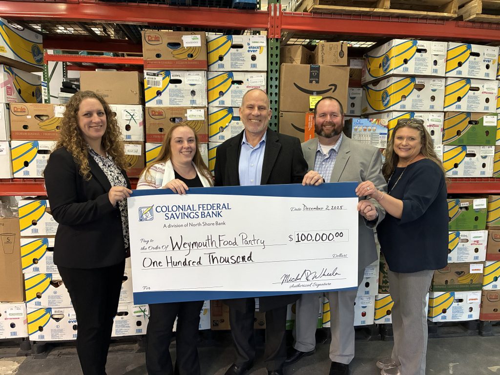 A check donation to Weymouth Food Pantry from our charitable giving program, The Giving Tree.