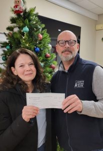 A check donation to Newton Food Pantry from our charitable from our giving program, The Giving Tree.