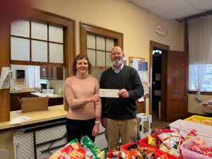 A check donation to Reading food pantry from our charitable giving program, The Giving Tree.