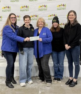 A check donation to Salem Pantry from our charitable giving program, The Giving Tree.