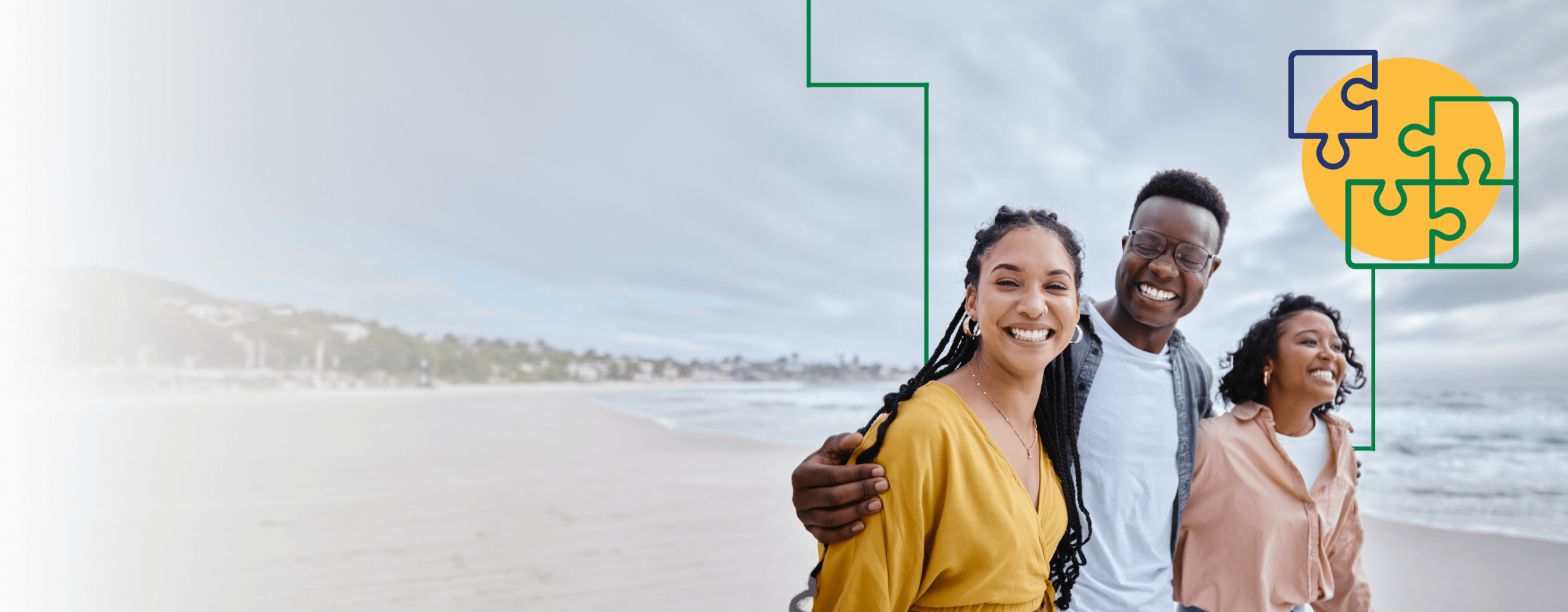 A group of young adults walking on the shoreline in an embrace.