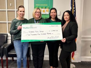 A check donation to Holbrook Public Schools from from our charitable giving program, The Giving Tree. 