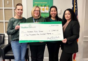 A check donation to Holbrook Public Schools from from our charitable giving program, The Giving Tree.
