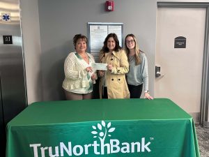 A check donation to Avon Public Schools from from our charitable giving program, The Giving Tree. 