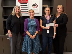 A check donation to Saugus high school from from our charitable giving program, The Giving Tree. 