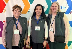 A group of TruNorth Bank employees attending a fundraiser for the YMCA in matching vests.